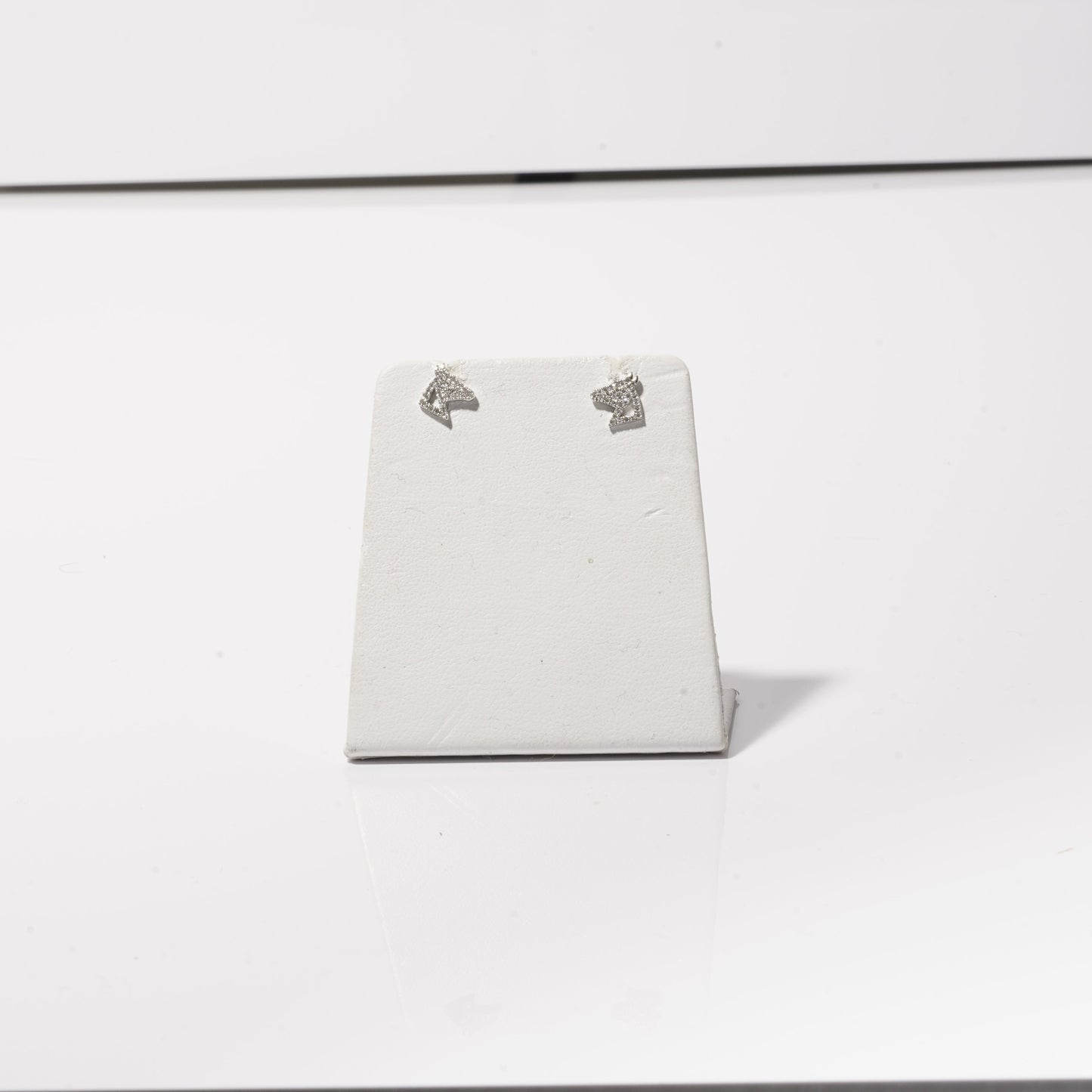 A photo of sparkly diamond horse head stud earrings.