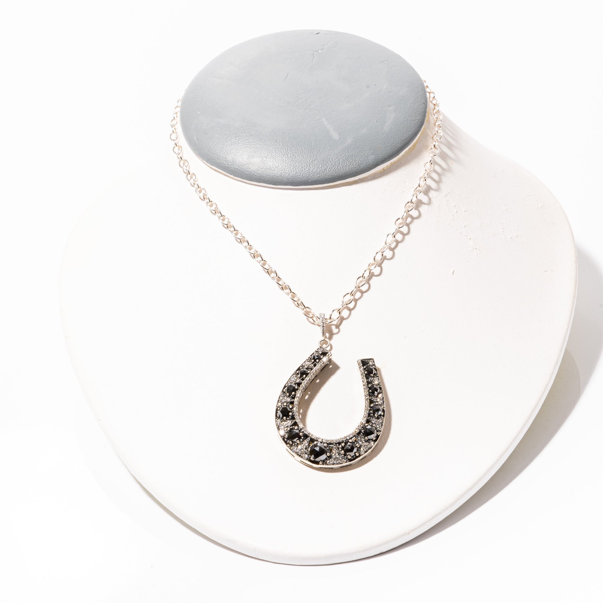 A photo of a Black & White Diamond Horse Shoe Pendant by ZDNY & CO.