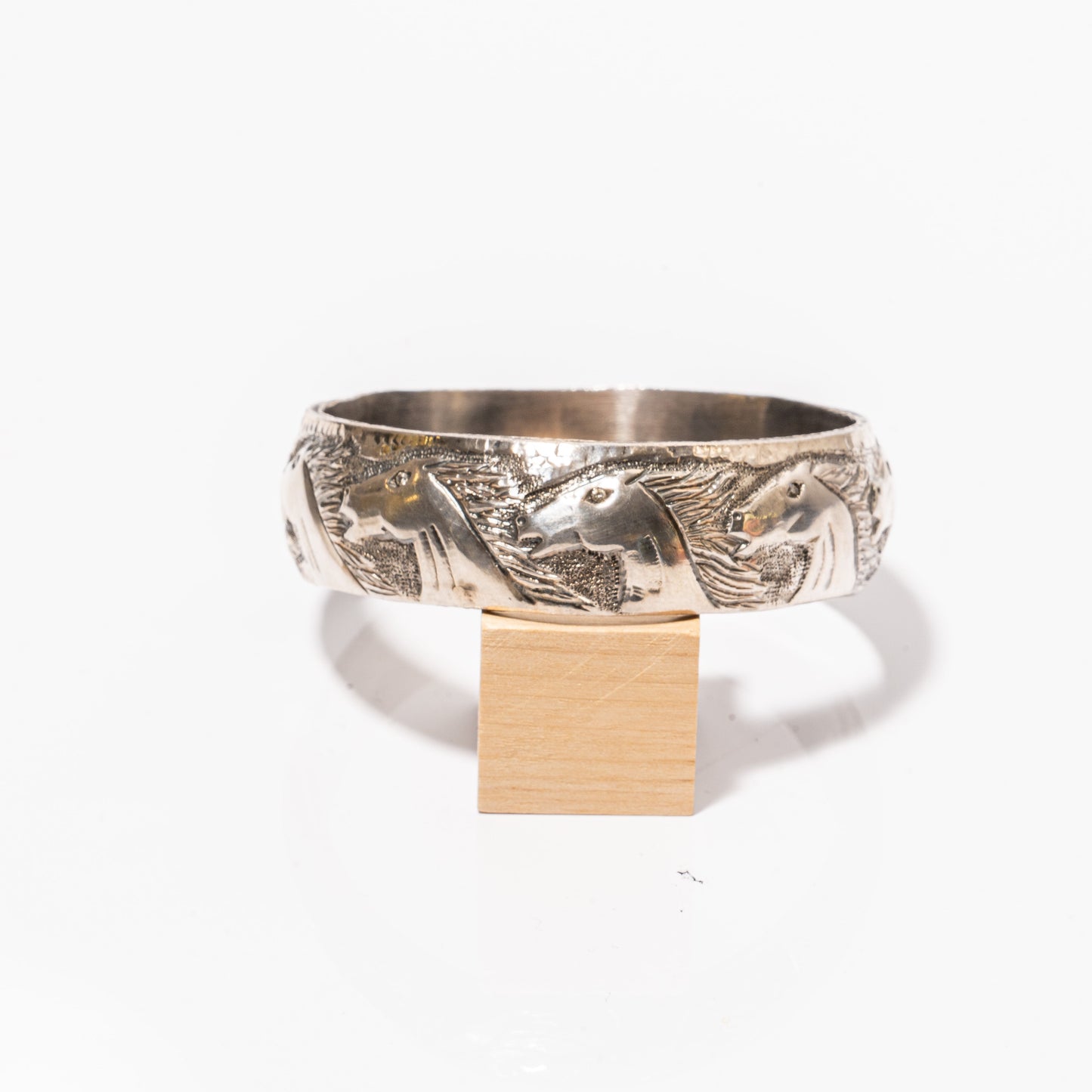 A photo of a single Hand Carved Sterling Silver Diamond Horse Head Bangle by ZDNY & CO.