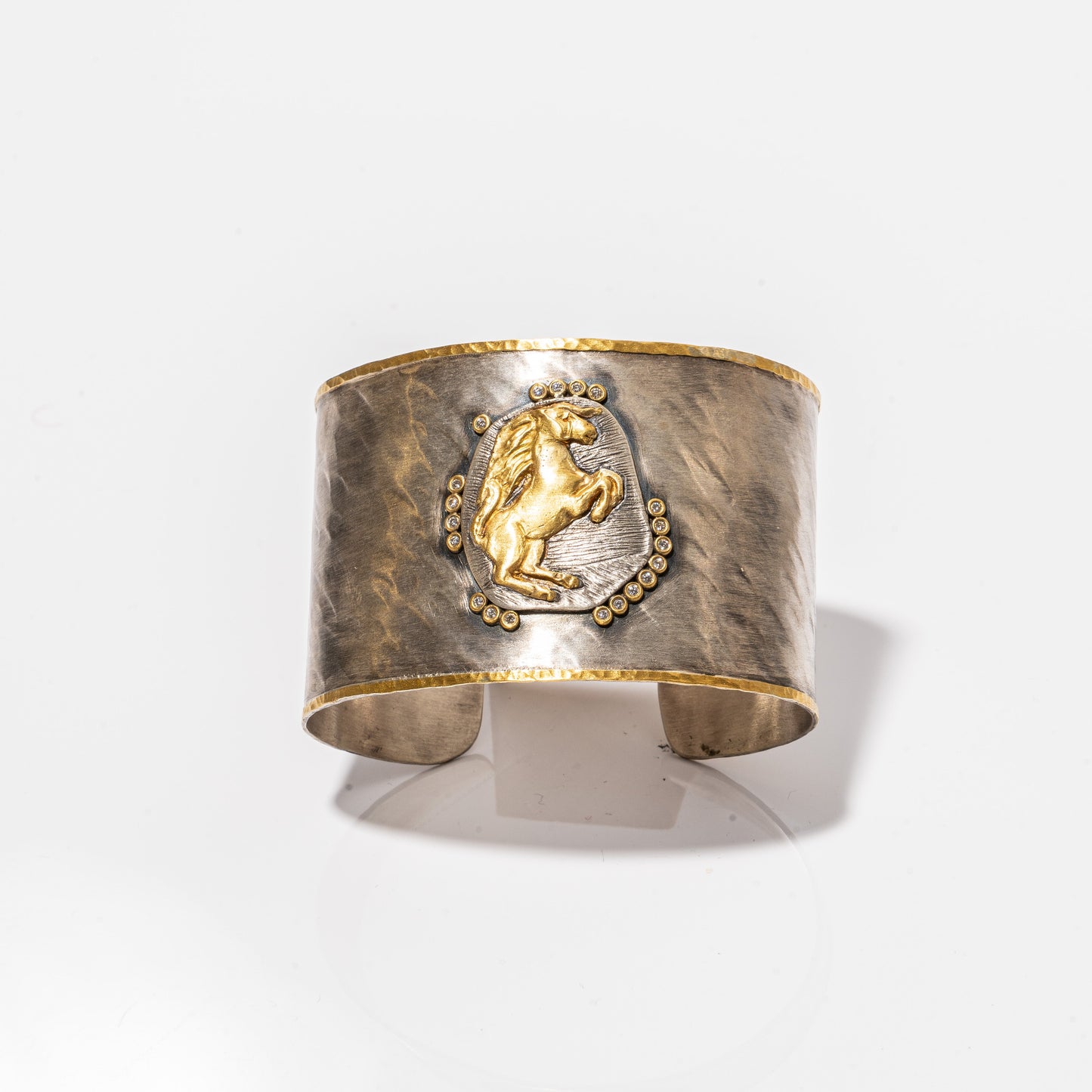 A photo of a Kurtulan Cuff with a horse on it.