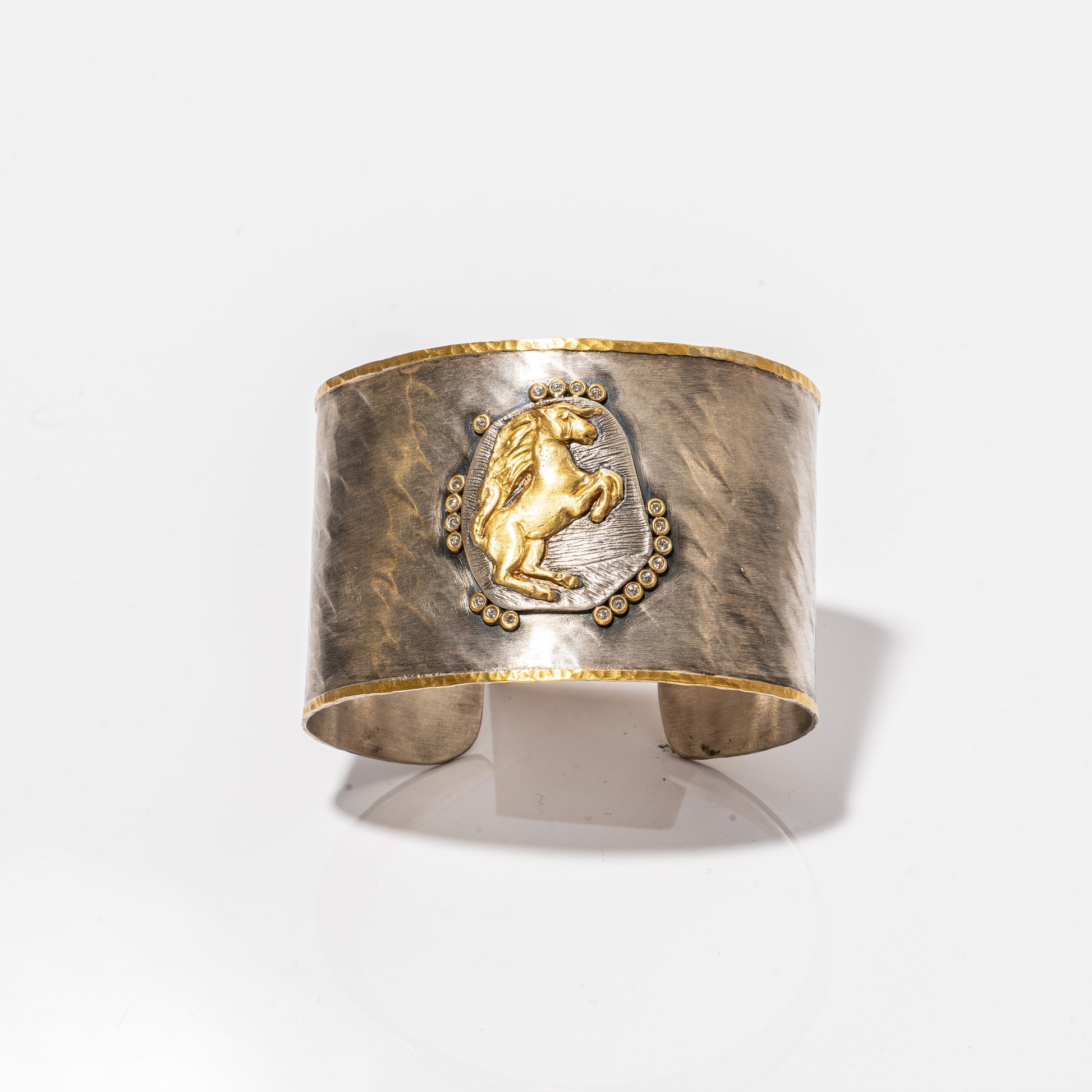 A photo of a Kurtulan Cuff with a horse on it.