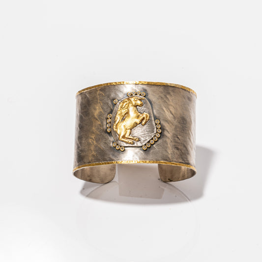 A photo of a Kurtulan Cuff with a horse on it.