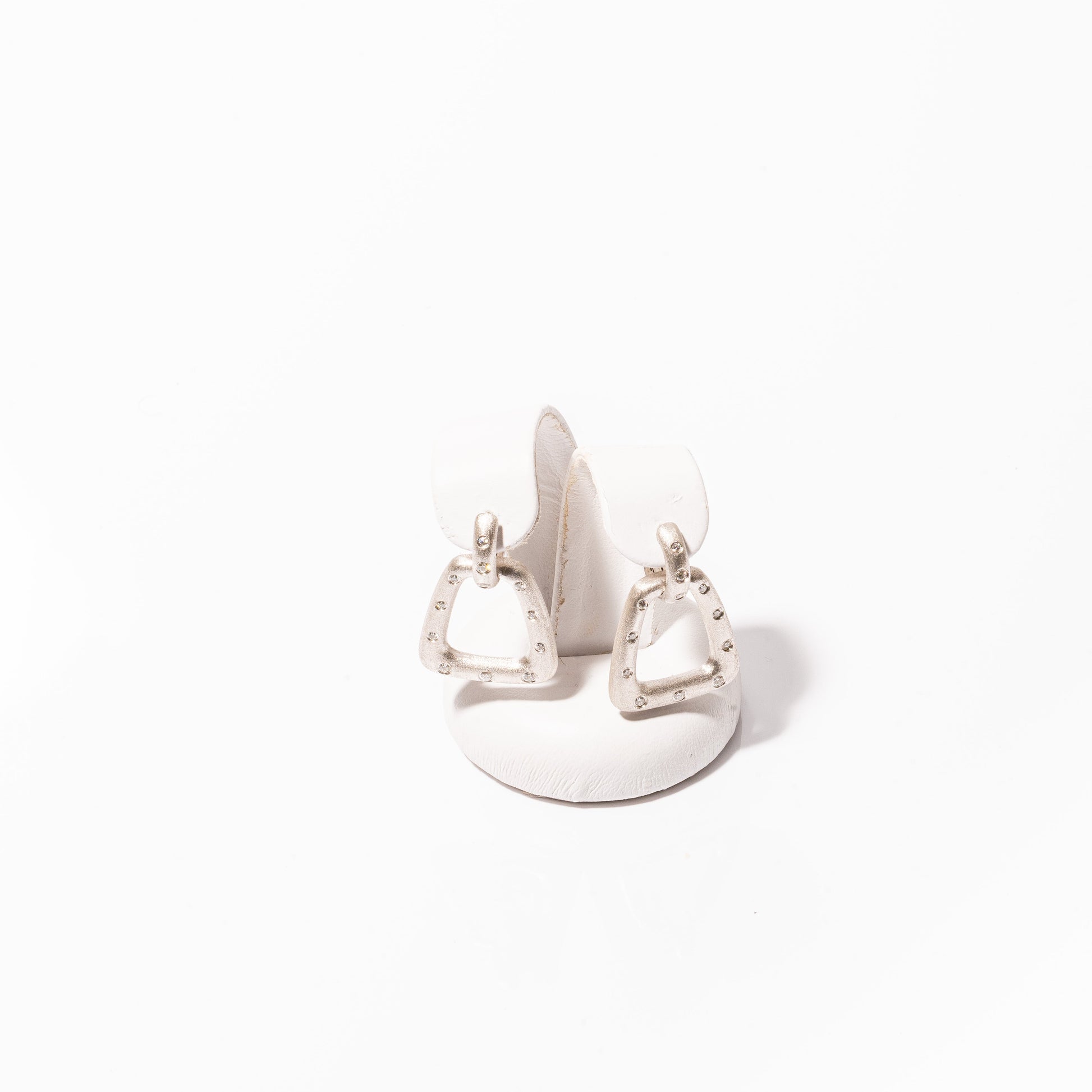 A photo of Nava Dee Stirrup Earrings in white gold.